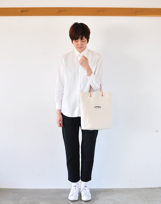 Person carrying TEMBEA PAPER TOTE canvas tote bag